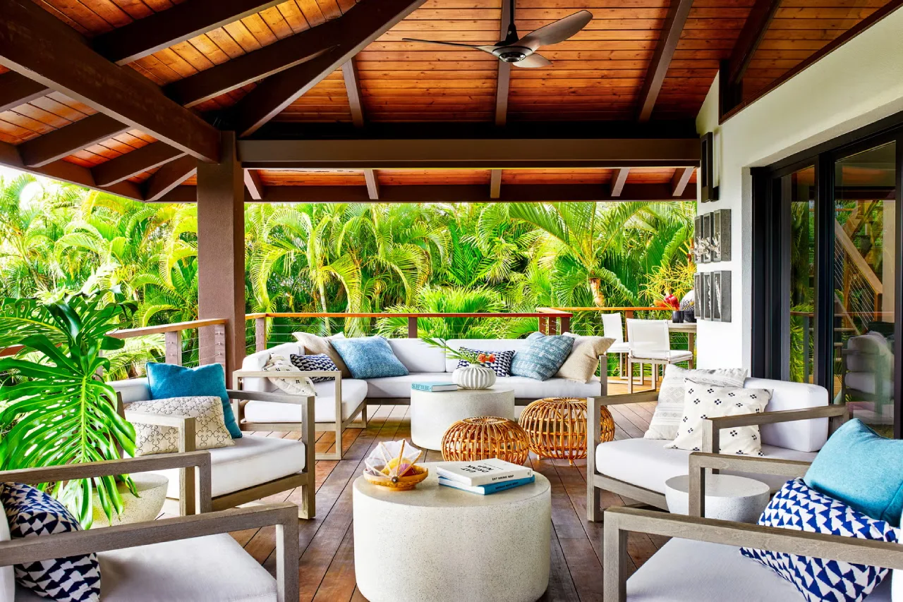 Grand wrap-around plantation style balcony with white pillars—classic colonial farmhouse exterior in the Western Ghats.